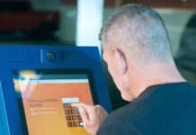 a man using touch screen kiosk