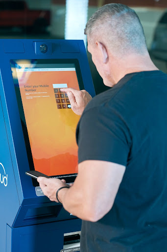 a man using touch screen kiosk